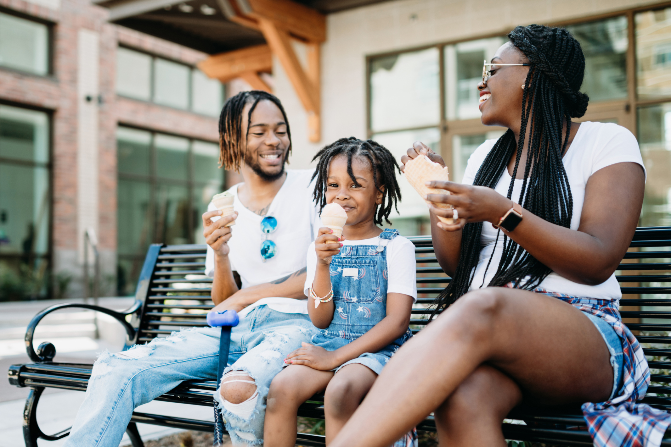 Family on bench eating ice cream