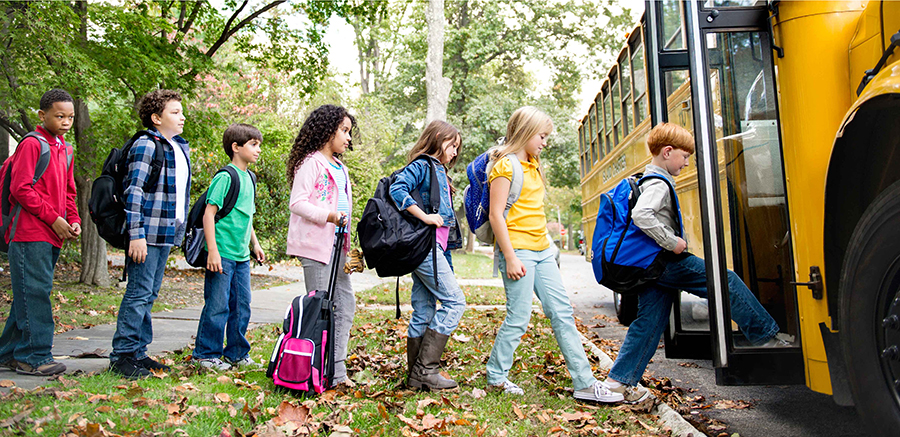 kids getting on a school bus